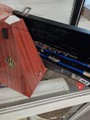 A CASED SLADE FLUTE AND A METRONOME.