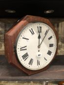 A GPO WALL MOUNTING DOUBLE ENAMEL FACED TIMEPIECE WITHIN AN OCTAGONAL MAHOGANY CASE. H 37.5cms.