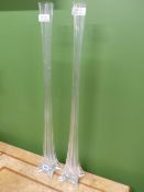 FIVE SLENDER GLASS VASES, THREE ON BUTTRESS FEET AND TWO ON CIRCULAR FEET, THE TALLEST. H 80cms.