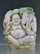 A CHINESE JADEITE CARVING OF BUDAI SEATED AMONGST LINGZHI FUNGUS, THE STONE GREY THROUGH PURPLE