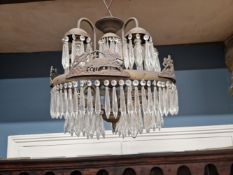 AN UNUSUAL LUSTRE HUNG BRASS CHANDELIER WITH TEN LIGHTS AND THE OUTER RIM WITH CHARIOTEERS.