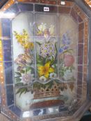A FRAMED LEADED GLASS PANEL PAINTED WITH A BASKET OF FLOWERS. 85 x 66cms.