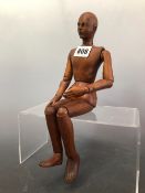 AN ARTISTS LAY FIGURE JOINTED AND DOWELLED IN WOOD. H 33cms.