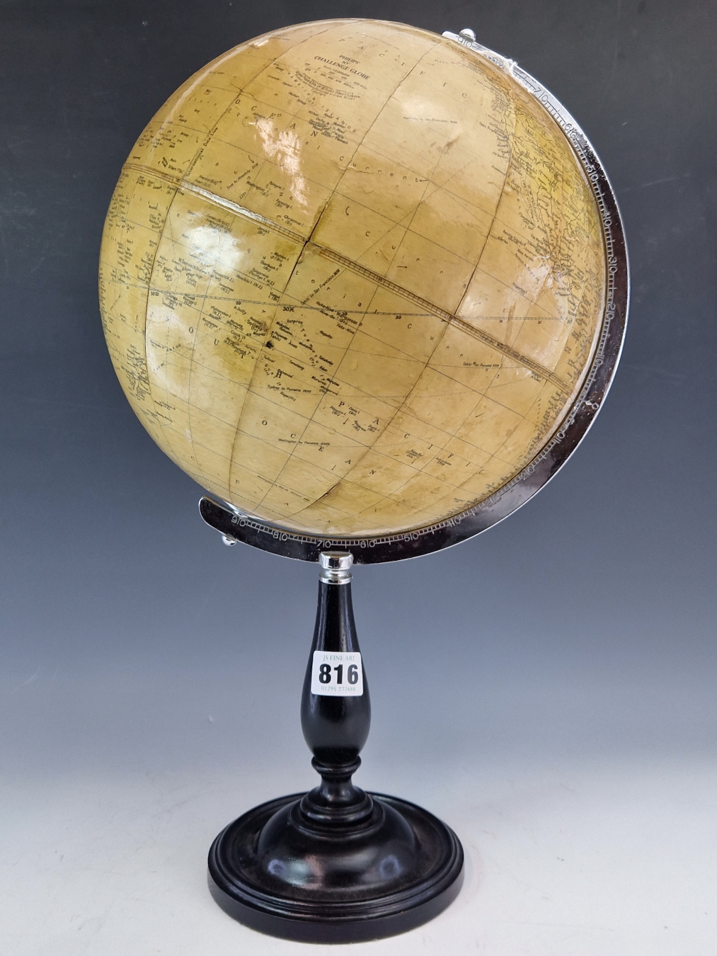A 1961 PHILIPS CHALLENGE TERRESTRIAL GLOBE ON AN EBONISED STAND WITH A CIRCULAR FOOT.