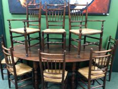A SET OF EIGHT CONTEMPORARY OAK RUSH SEATED CHAIRS INCLUDING TWO WITH ARMS, EACH WITH A ROW OF