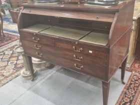 A 19Th C. MAHOGANY ROLL TOP DESK WITH A BRASS GALLERIED BACK RECESSED TO THE TOP, THE ROLL TOP