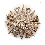 AN ANTIQUE DIAMOND STAR BURST BROOCH. THE EIGHT POINTED STAR INTERSPERSED WITH EIGHT STEMMED