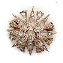 AN ANTIQUE DIAMOND STAR BURST BROOCH. THE EIGHT POINTED STAR INTERSPERSED WITH EIGHT STEMMED