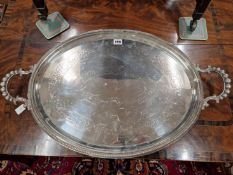 A WALKER AND HALL ELECTROPLATE OVAL TRAY WITH A BEADED RIM AND HANDLES. W 70cms.
