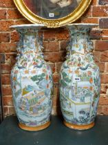 A PAIR OF 19th C. CHINESE VASES PAINTED WITH FIGURE PANELS ON A GROUND OF FLOWERS, FRUIT AND