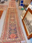 A NEAR PAIR OF ANTIQUE PERSIAN TRIBAL RUNNERS. 302 x 86 AND 305 x 93cms (2)