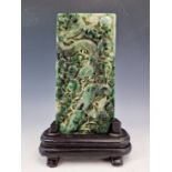 A CHINESE JADEITE RECTANGULAR PLAQUE CARVED IN RELIEF ON ONE SIDE WITH A DRAGON AMONGST BAMBOO. 19 x