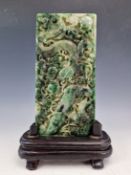 A CHINESE JADEITE RECTANGULAR PLAQUE CARVED IN RELIEF ON ONE SIDE WITH A DRAGON AMONGST BAMBOO. 19 x