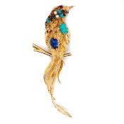 A LARGE GEM SET BIRD PERCHED ON STYLISED BRANCH. THE BIRD SET WITH A VARIETY OF GEMSTONES TO INCLUDE