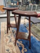 A PAIR OF HARDWOOD BAR STOOLS WITH BOWED SEATS SUPPORTED BY PLANK SIDES FLARING DOWN TO FORM THE