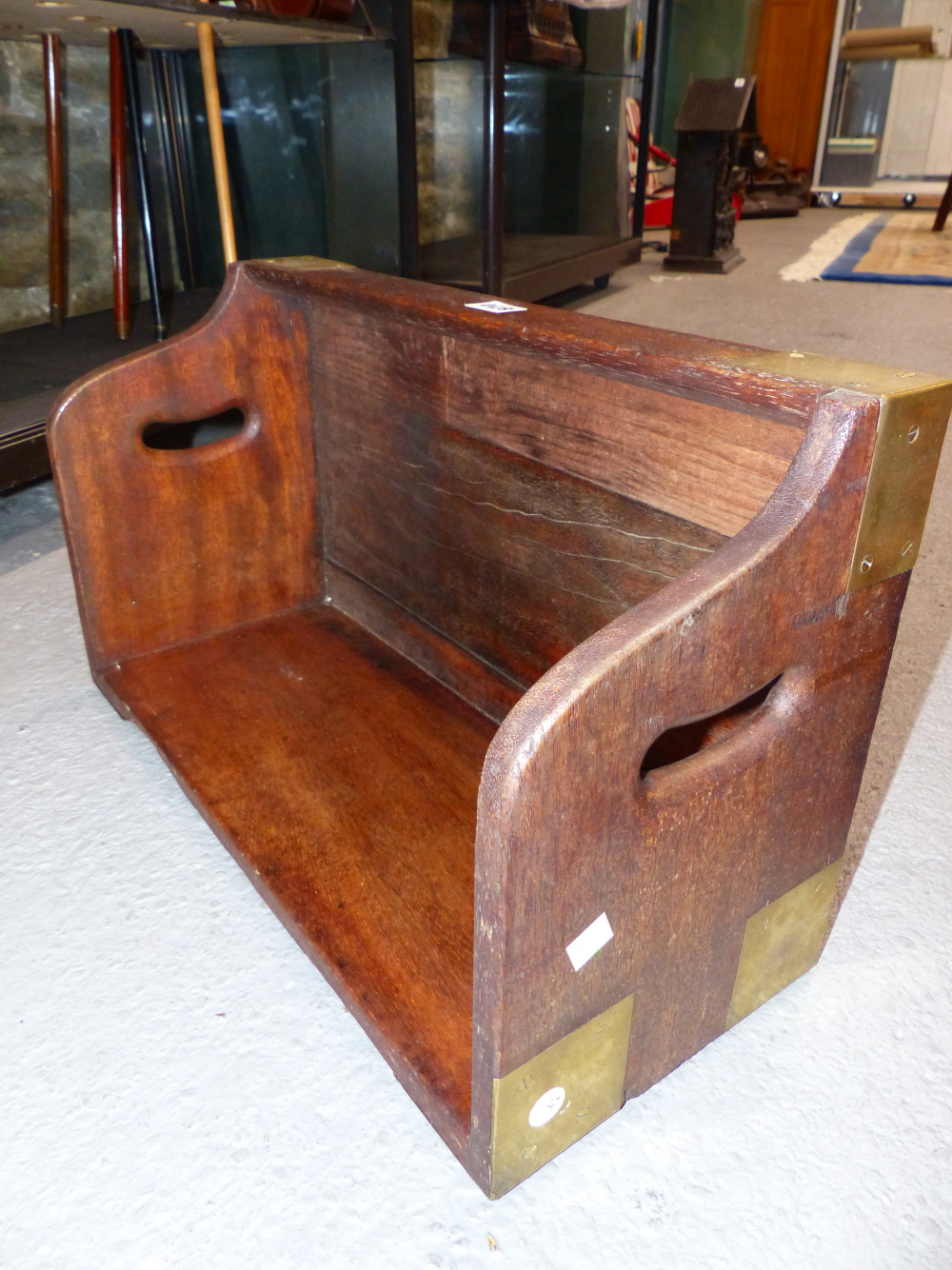 A BRASS BOUND TEAK BOOK CARRIER, THE NARROW SIDES PIERCED WITH HANDLES. W 53cms.