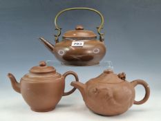 THREE CHINESE YIXING RED WARE TEA POTS, ONE COVER WITH A MOVEABLE DRAGONS HEAD, THE POLISHED EXAMPLE