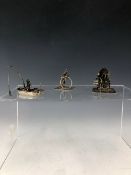 THREE WHITE METAL MINIATURES DEPICTING A FISHERMAN IN HIS BOAT A PUNCH AND JUDY SHOW AND A MAN