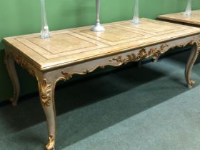 A CREAM GROUND CENTRE TABLE DETAILED IN GILT, THE RECTANGULAR TOP OVER A SHELL CENTRED SCROLLING