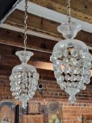 A PAIR OF GLASS CEILING LIGHTS, THE CIRCULAR TOPS SUPPORTING BEADED BASKETS