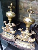 A PAIR OF 19th C. BRASS AND IRON FIRE DOGS WITH CINQUEFOIL SPIRE TOPS RESTING ON PAIRS OF DOLPHINS