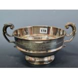 A SILVER TWO HANDLED BOWL BY CARRINGTONS, BIRMINGHAM 1912, INCISED WITH A 1974 PRESENTATION