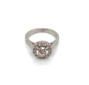 A GIA ROUND BRILLIANT CUT DIAMOND AND PLATINUM RING. THE CENTRE DIAMONDS 0.71cts, SURROUNDED BY A