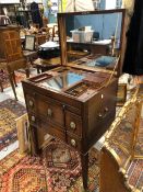 A GEORGE III MAHOGANY BEDSIDE CABINET, THE HINGED MIRROR LINED LID OPENING ONTO COMPARTMENTS AND