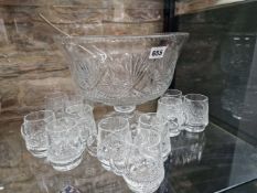 AN EDINBURGH CRYSTAL PUNCH BOWL RAISED ON A STAR CUT FOOT AND WITH TWELVE MUGS CUT EN SUITE, THE