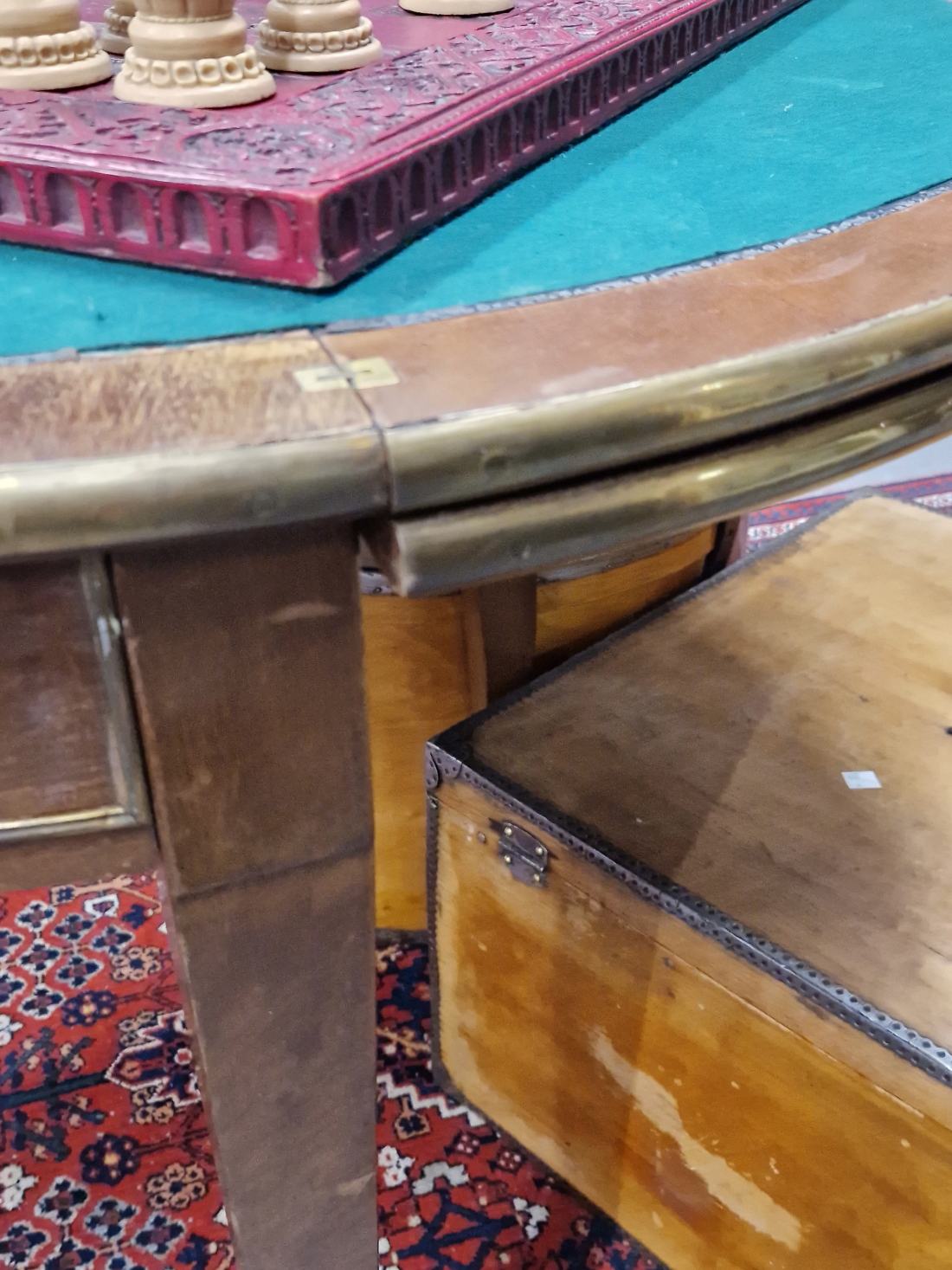 A 19th C. MAHOGANY DEMILUNE BRASS EDGED TRIPLE TOP GAMES AND TEA TABLE ON TAPERING SQUARE LEGS. W - Image 2 of 4