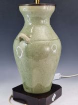 A TWO HANDLED CRACKLED CELADON GLAZED VASE AS A LAMP. H 45cms.