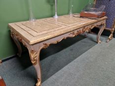 A CREAM GROUND CENTRE TABLE DETAILED IN GILT, THE RECTANGULAR TOP OVER A SHELL CENTRED SCROLLING