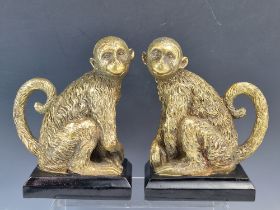 A PAIR OF DECORATIVE FIGURES/ BOOKENDS OF A MISCHIEVOUS PRIMATES