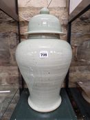 AN ORIENTAL  BALUSTER JAR AND COVER, POSSIBLY KOREAN, THE PALE CELADON GLAZE WITH PEPPERED MARKINGS.