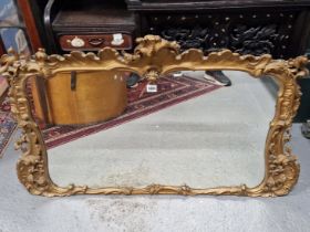 A 19th C. MIRROR IN A GILT ROCOCO FOLIAGE FRAME. 69 x 99cms