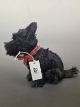 A SOFT TOY SEATED SCOTTIE DOG WEARING A TARTAN COLLAR. H 24cms.