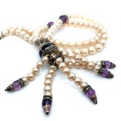 A FAUX PEARL, MARCASITE AND AMETHYST BEAD NECKLACE. THE CENTRAL PENDANT WITH BLACK ENAMEL AND FIVE