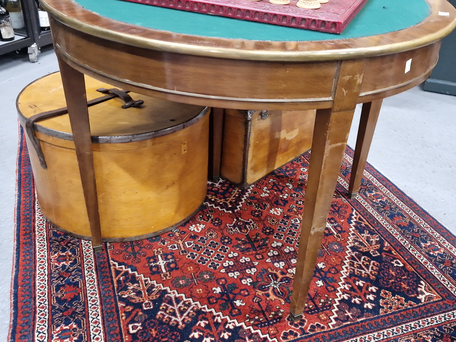 A 19th C. MAHOGANY DEMILUNE BRASS EDGED TRIPLE TOP GAMES AND TEA TABLE ON TAPERING SQUARE LEGS. W - Image 4 of 4