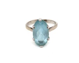 A VINTAGE OVAL CUT AQUAMARINE RING, SET IN A RAISED SIX CLAW SETTING. THE SHANK STAMPED 18ct,
