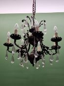 A CHANDELIER WITH THE UPPER TIER HUNG WITH PEAR SHAPED DROPS, THE EIGHT LIGHTS BELOW SIMILARLY