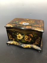 A 19th C. PAPIER MACHE TWO COMPARTMENT TEA CADDY PAINTED AND GILT WITH FLOWERS AND CONTAINING