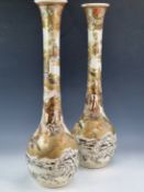A PAIR OF SATSUMA POTTERY BOTTLE VASES PAINTED WITH DEITIES FLYING ON THE BACKS OF EAGLES, CRANES