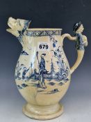AN 18th C. CREAMWARE JUG WITH A LION MASK SPOUT AND MALE FIGURE THUMB PIECE, THE BALUSTER SIDES