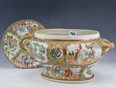 A CANTON OVAL TUREEN WITH GILT HANDLES. W 34cms. TOGTHER WITH A CANTON PLATE. Dia. 21cms.