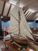 A LARGE VICTORIAN POND YACHT MODEL SAILING BARGE WITH FIVE SAILS, FROM STERN TO BOW SPRIT. 172cms.