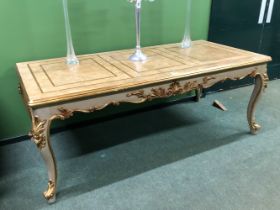 A CREAM GROUND CENTRE TABLE DETAILED IN GILT, THE RECTANGULAR TOP OVER A SHELL CENTRED SCROLLING