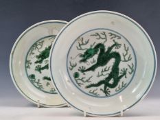 A PAIR OF CHINESE SHALLOW BOWLS PAINTED IN GREEN CENTRALLY WITH DRAGONS CHASING FLAMING PEARLS, SEAL