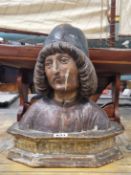 A PAINTED PLASTER AND WOOD BUST OF A 15th C. MAN WEARING A CAP OVER HIS LONG HAIR. H 33cms.