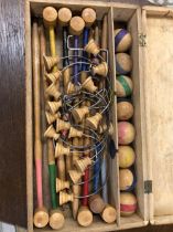 A WOODEN CASED TABLE TOP CROQUET SET, THE BOX. W 37cms.