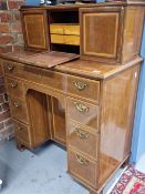 A 19th C. SATIN WOOD BANDED KNEE HOLE DESK WITH DRAWERS FLANKING THE KNEEHOLE CUPBOARD, THE TOP WITH